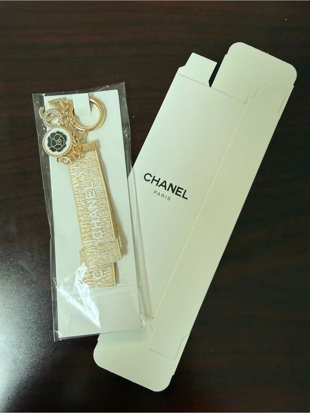 CHANEL Gold Metallic Logo Strap Key Holder with Camellia Charm